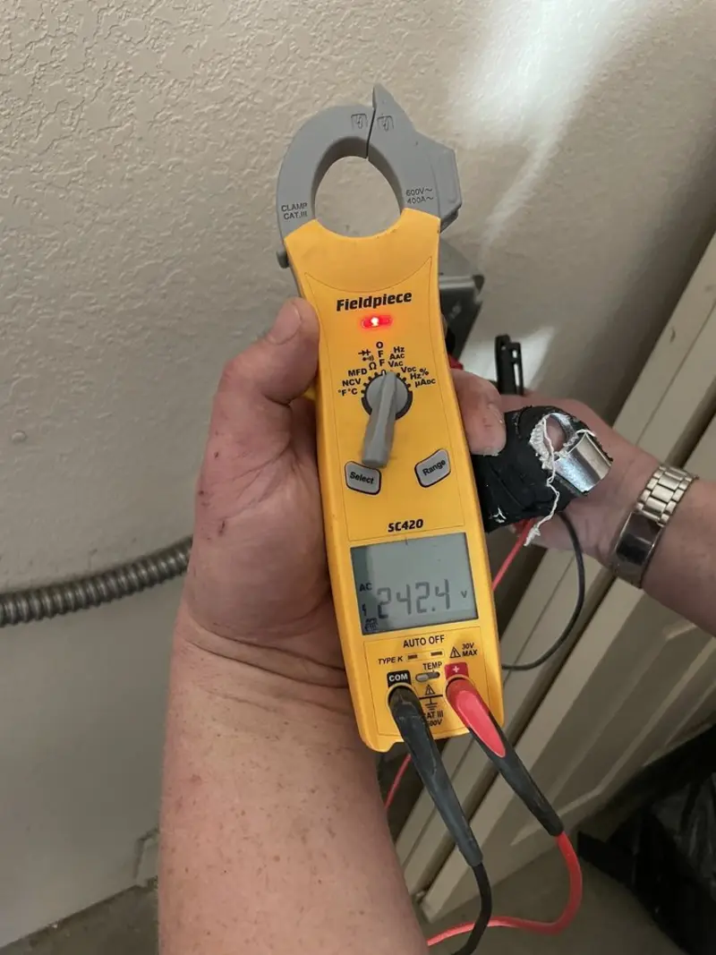 Voltage testing with clamp meter during Electrical Installation Services in Clifton
